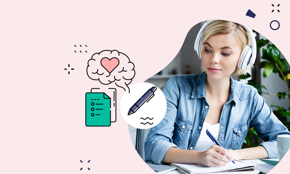 Person writing at desk studying